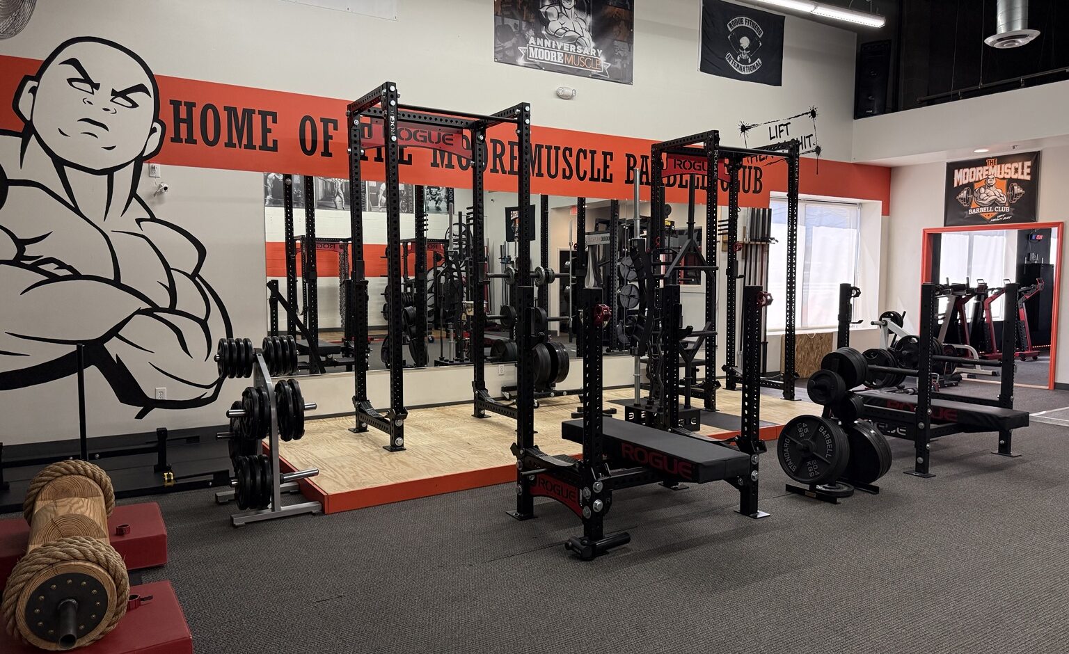 Priority Health & Fitness strength training gym featuring Rogue power racks and lifting platforms at the MooreMuscle Barbell Club in Maryland
