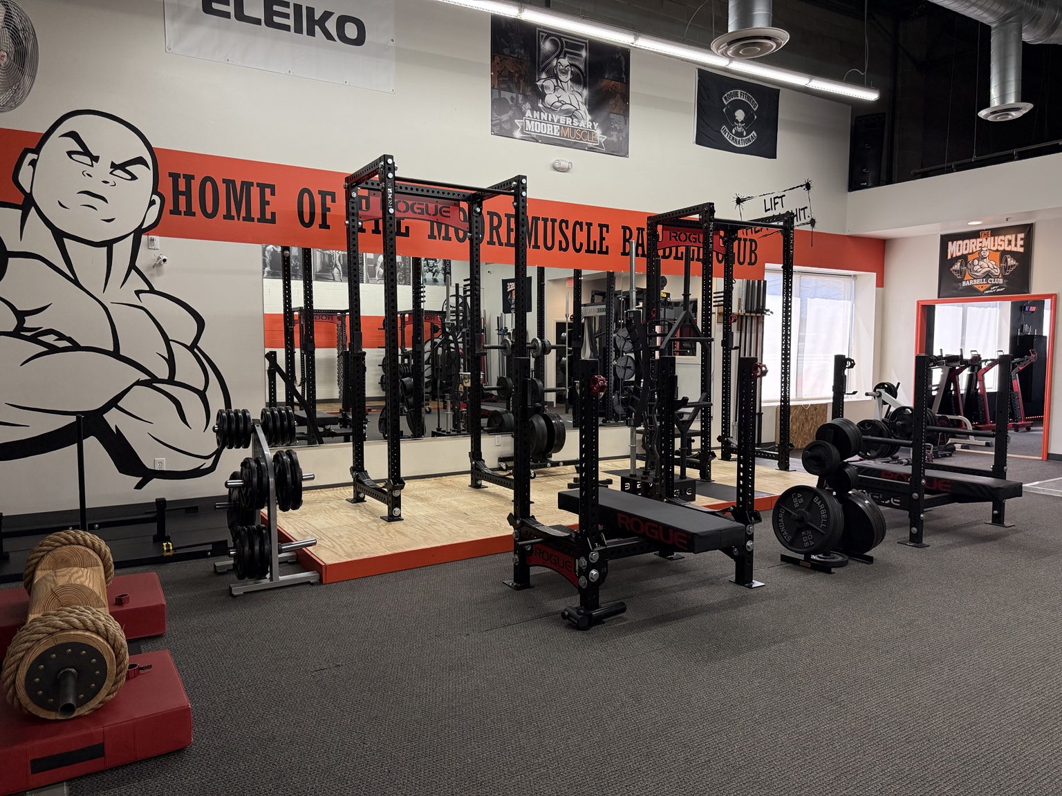 Priority Health & Fitness strength training gym featuring Rogue power racks and lifting platforms at the MooreMuscle Barbell Club in Maryland